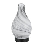 Marbled glass electric diffuser with black base, swirl pattern, two control buttons