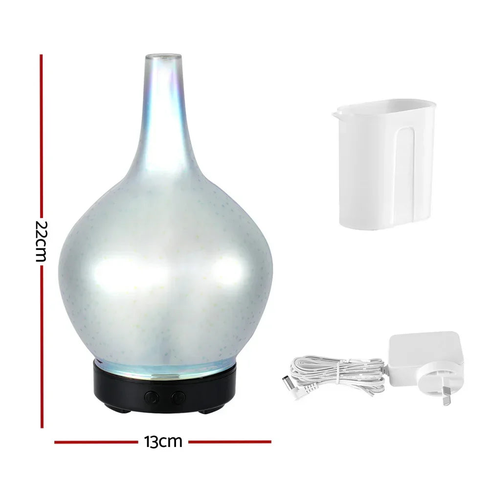 Pearl white aroma diffuser with measuring cup and power adapter, 22cm tall, 13cm wide.