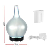 Pearl white aroma diffuser with measuring cup and power adapter, 22cm tall, 13cm wide.