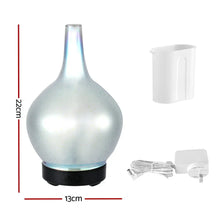 Pearl white aroma diffuser with measuring cup and power adapter, 22cm tall, 13cm wide.