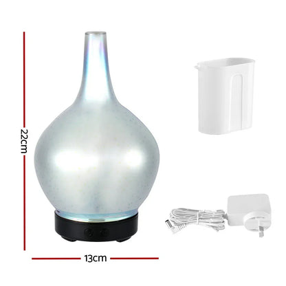 Pearl white aroma diffuser with measuring cup and power adapter, 22cm tall, 13cm wide.