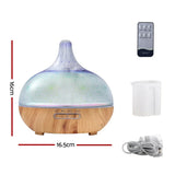 Aromatherapy essential oil diffuser with wood grain base, remote control, measuring cup, and power cord, 16x16.5cm.
