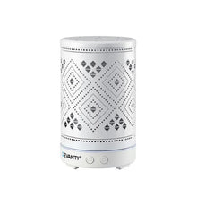 White electric aroma diffuser with geometric cutout design, power buttons on base