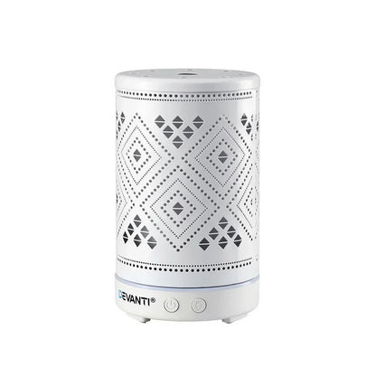 White electric aroma diffuser with geometric cutout design, power buttons on base