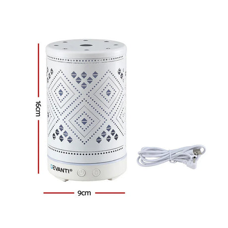 White cylindrical electric aroma diffuser with geometric cutout pattern, size 16cm x 9cm, and power cable.