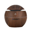 Wood grain round essential oil diffuser with power button and open lid, DEVANTI logo visible.
