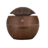 Wood grain round essential oil diffuser with power button and open lid, DEVANTI logo visible.