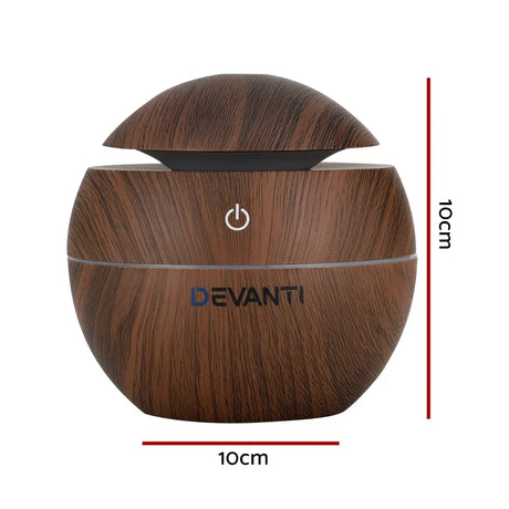 Round wood grain aroma diffuser with power button, 10cm by 10cm, Devanti logo visible.