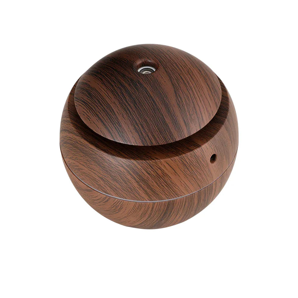 Round wood grain essential oil diffuser with modern minimalist design on white background