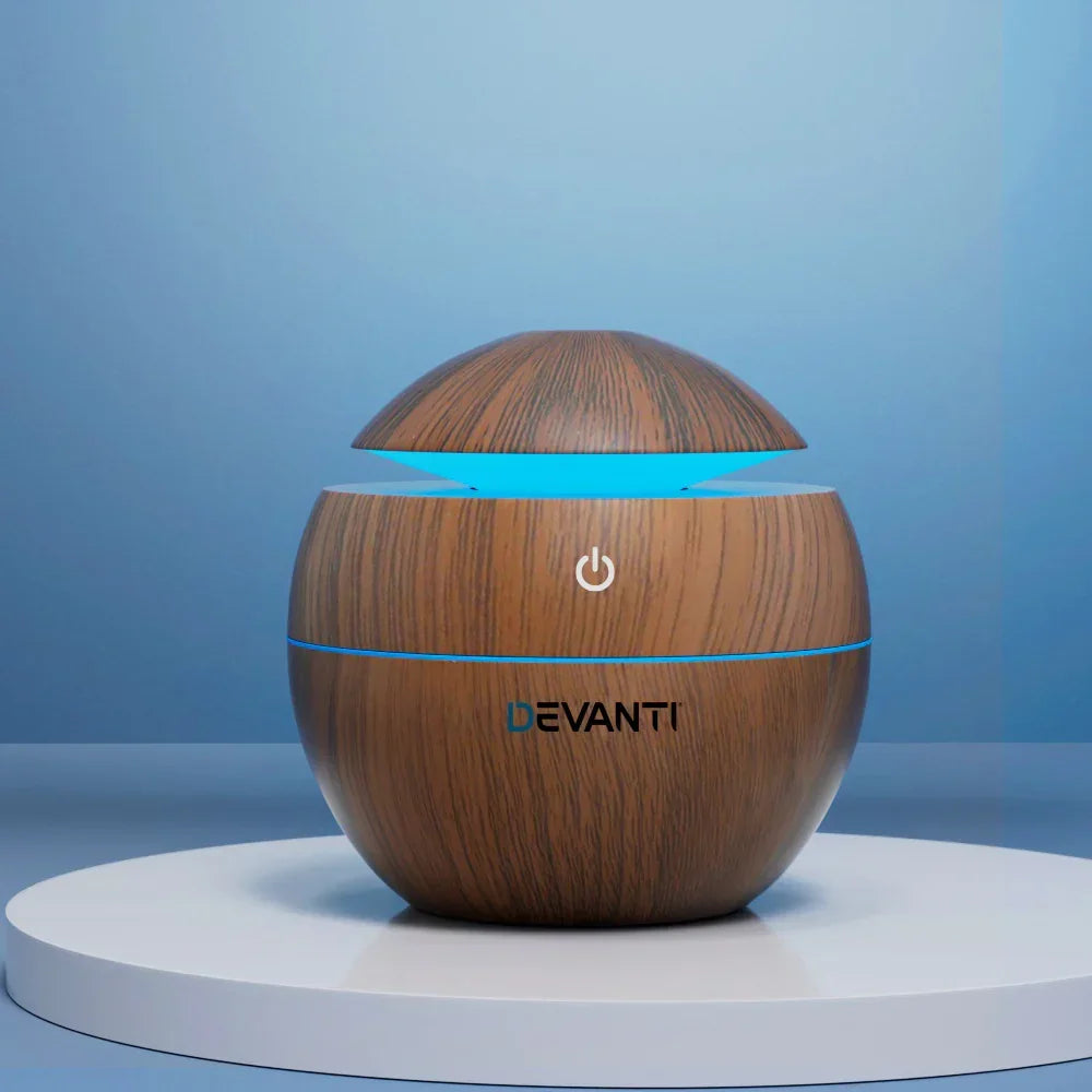 Wood grain sphere aroma diffuser with blue LED light on display stand