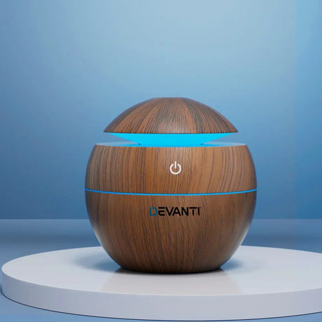 Wood grain sphere aroma diffuser with blue LED light on display stand