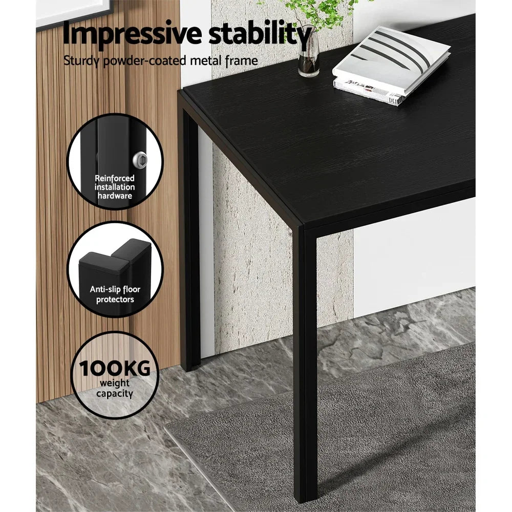 Black dining table with metal frame, anti-slip feet, 100kg capacity, and books on top.
