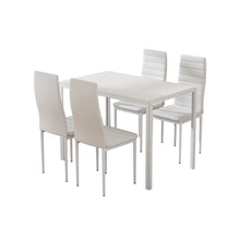 Modern white dining table set with four matching padded chairs on a white background