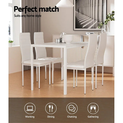 Modern white dining table set with four chairs in a stylish, bright dining room