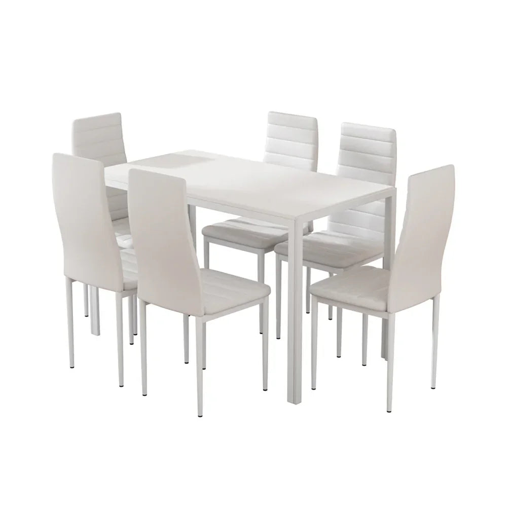 Modern white dining table set with six padded chairs on a white background