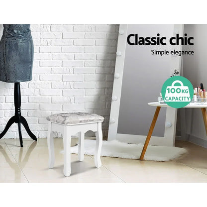 White vanity stool with cushioned floral seat, 100kg capacity, in chic bedroom setting
