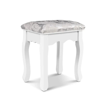 White wooden vanity stool with patterned cushioned seat and curved legs on white background