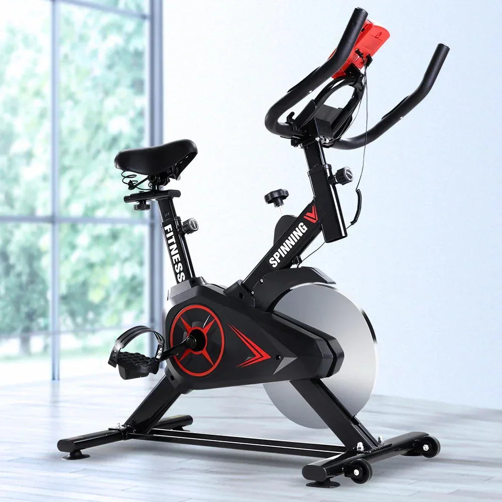 Indoor exercise bike with adjustable seat and handlebars, black and red spinning cycle