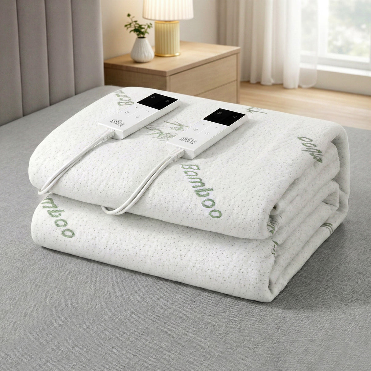 Folded bamboo electric blanket with dual controllers on a bed in a modern bedroom