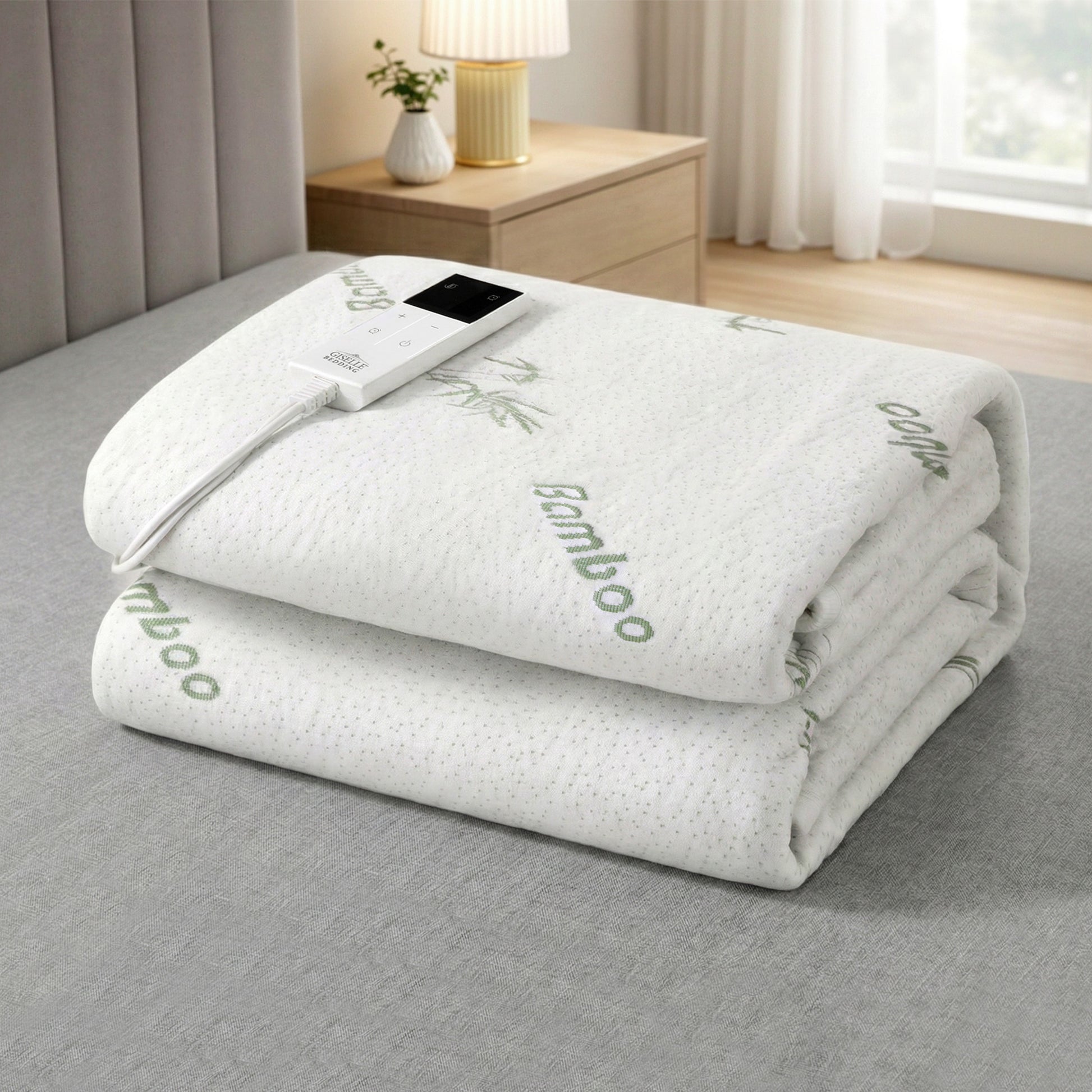 Folded bamboo electric blanket with digital controller on bed in modern bedroom