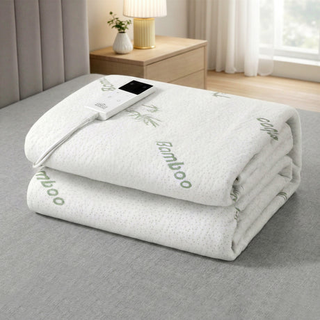 Folded bamboo electric blanket with digital controller on bed in modern bedroom