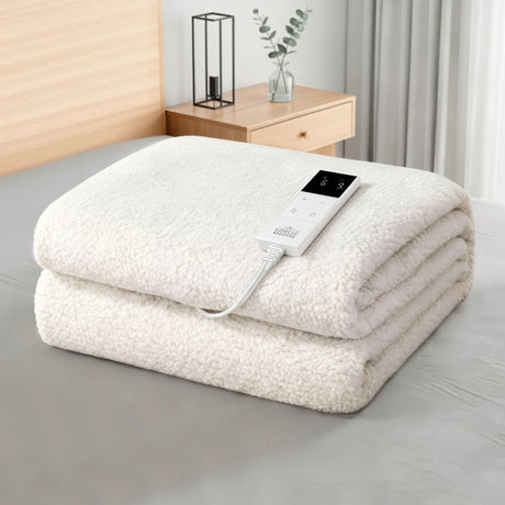 Electric heated blanket with remote control folded on bed in modern bedroom