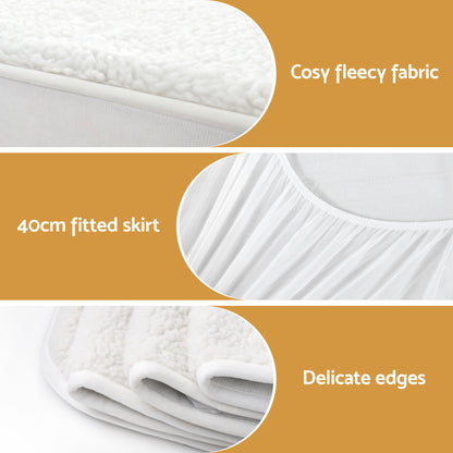 White fitted mattress protector with fleecy fabric, 40cm skirt, and delicate edges.