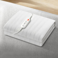 White electric blanket with attached control switch on a bed, bedding accessory