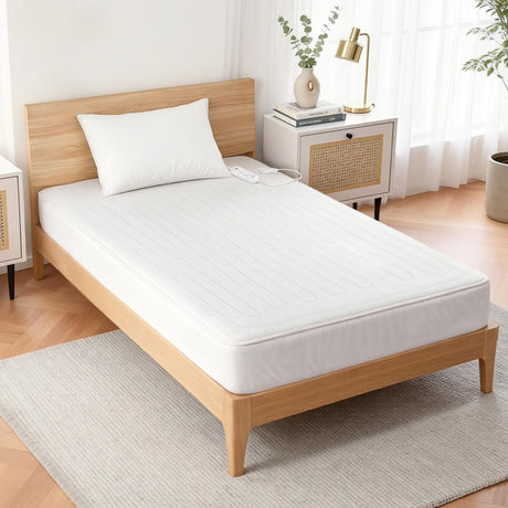 Single bed with white electric blanket, wooden frame, minimalist bedroom decor