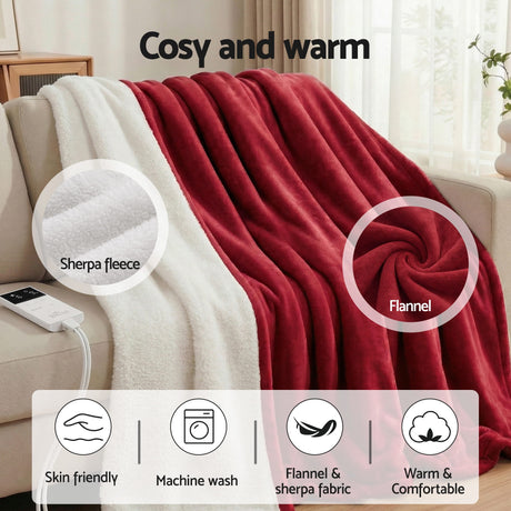 Red flannel and white sherpa fleece throw blanket draped on a sofa, cosy and warm.