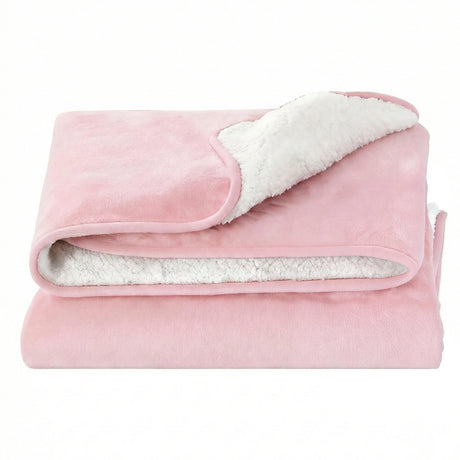 Soft pink sherpa fleece throw blanket with white fluffy lining, neatly folded