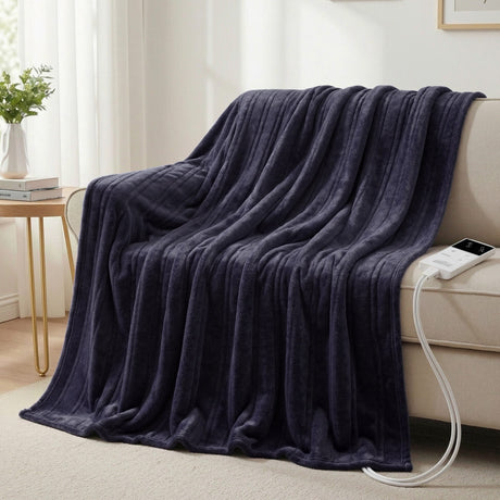 Dark grey heated electric throw blanket draped over sofa in cozy living room