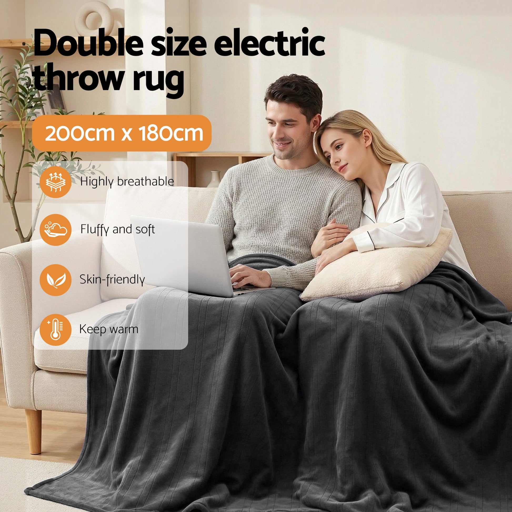 Double size electric throw rug 200x180cm, grey, on a couple relaxing on a sofa indoors