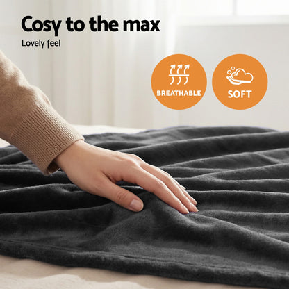 Hand touching soft, breathable grey throw rug on bed, cozy home decor blanket