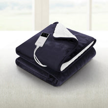 Dark electric heated throw blanket with digital controller on a light sofa