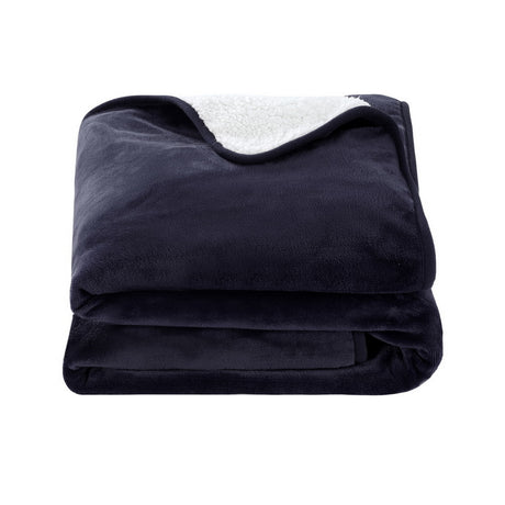 Folded dark grey fleece throw blanket with white sherpa lining on a white background