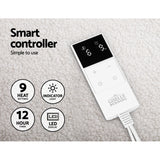 Electric blanket controller with LED display, 9 heat settings, timer, and indicator light on fleece fabric.