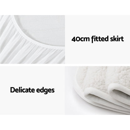 White mattress protector with 40cm fitted skirt and delicate edges, close-up details