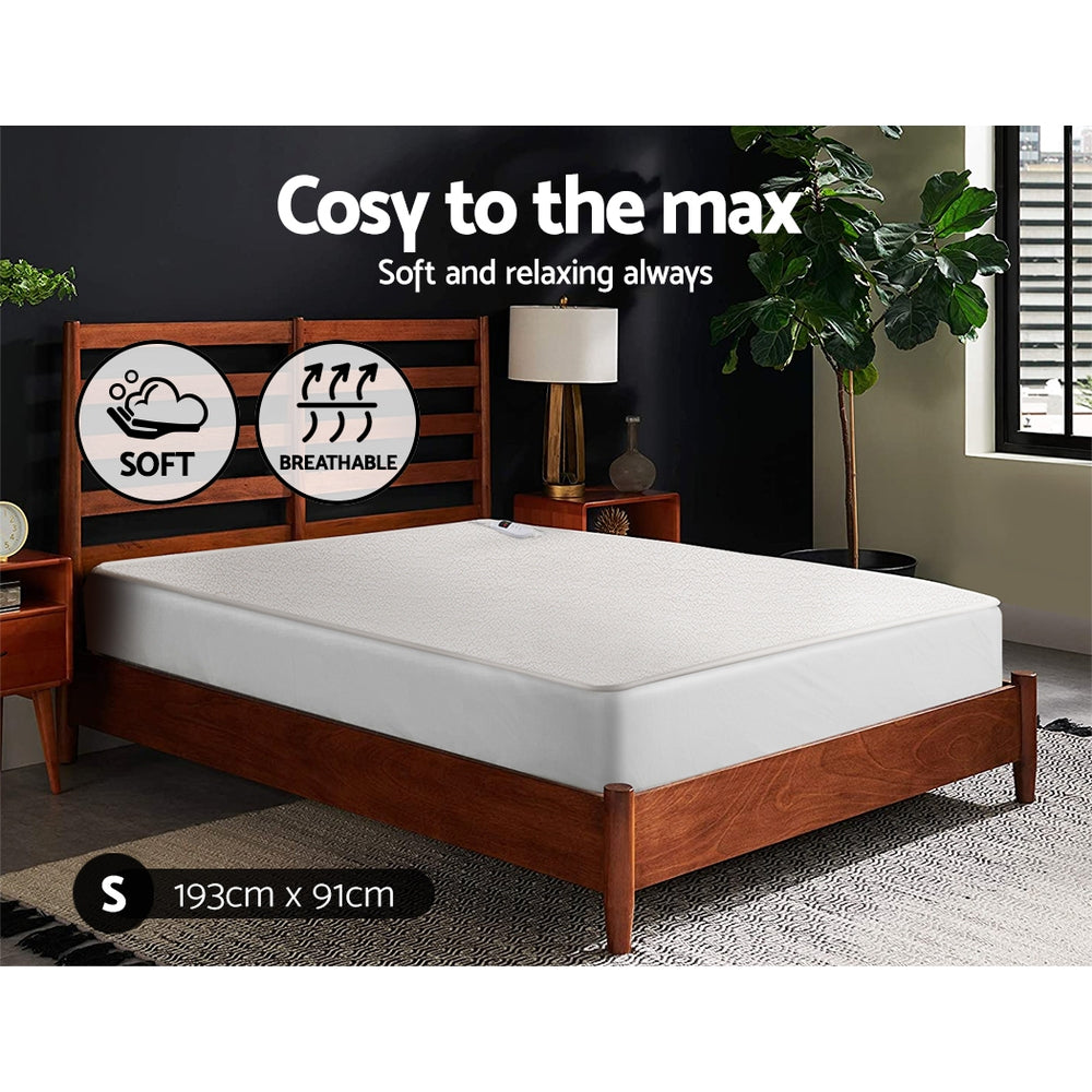 Single size memory foam mattress on wooden bed frame, soft and breathable, in modern bedroom