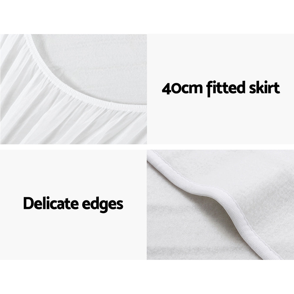 White fitted mattress protector with 40cm skirt and delicate edges, close-up details