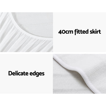 White fitted mattress protector with 40cm skirt and delicate edges, close-up details