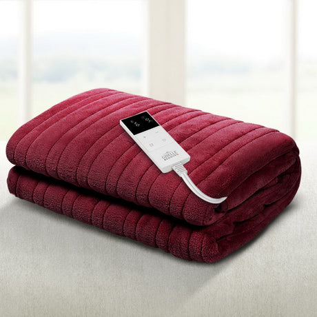 Burgundy electric heated throw rug with remote control on a light surface