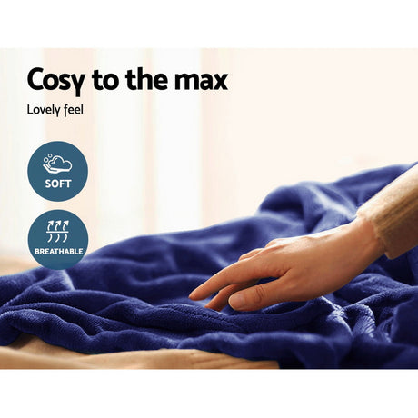 Hand touching soft, breathable navy blue throw rug with cosy, comfortable texture.