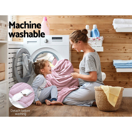 Woman and child with pink machine washable throw rug in laundry room, detachable cord shown.