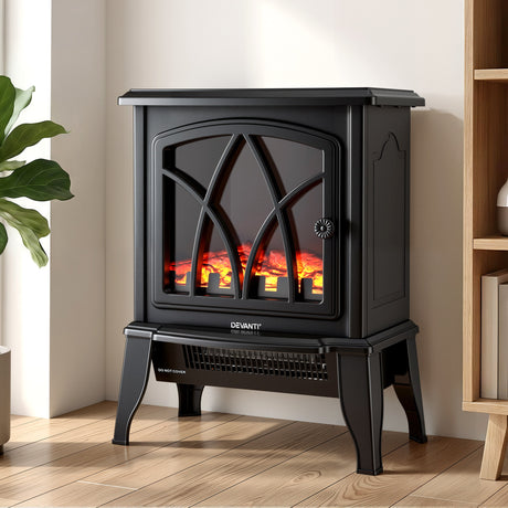 Black electric fireplace heater with realistic flame effect in modern living room corner