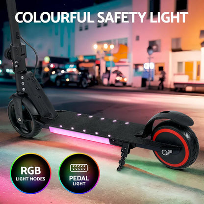 Electric scooter with RGB pedal lights and safety lighting on a city street at night