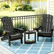 Black Adirondack patio chairs with side table on blue patterned rug, perfect for outdoor relaxation.