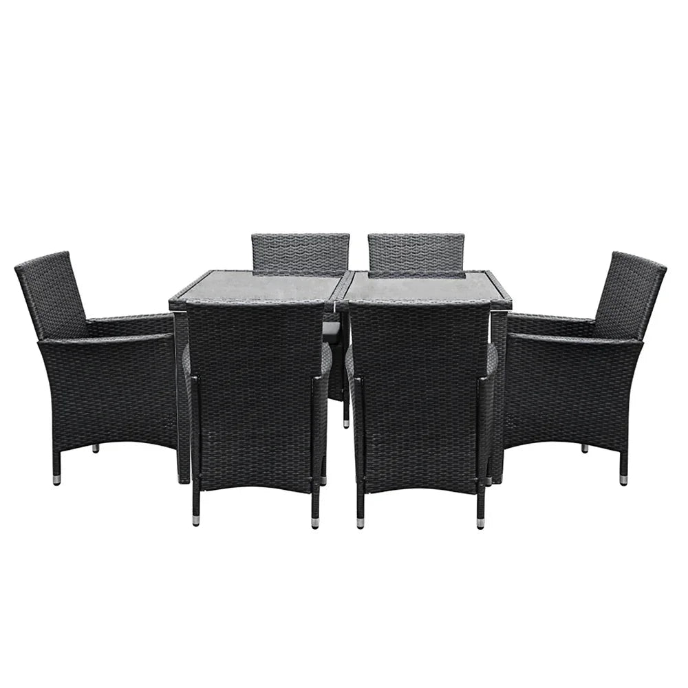 Outdoor wicker dining set with glass-top table and six black chairs