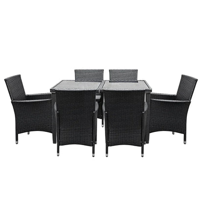 Outdoor wicker dining set with glass-top table and six black chairs