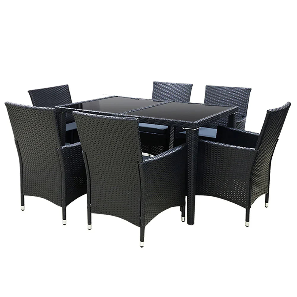 Black rattan outdoor dining set with glass-top table and six matching armchairs